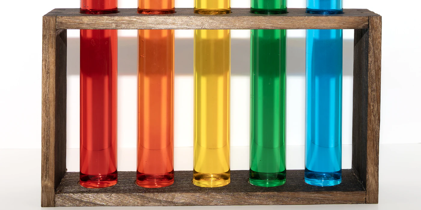Row of test tubes in colors from red to blue, like a pH scale