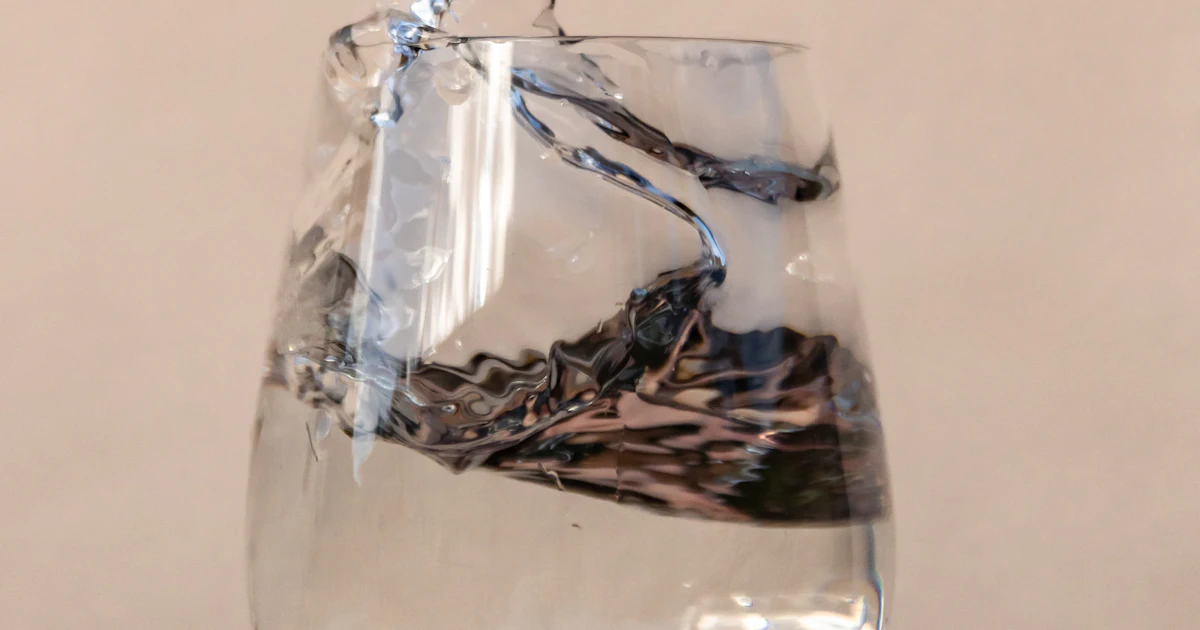Water pouring into a drinking glass